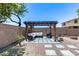 Backyard area with shade pergola, patio furniture, desert landscaping, and block wall for added privacy at 1359 E 12Th St, Casa Grande, AZ 85122