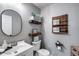 Cozy bathroom featuring a white vanity, floating shelves, and decorative accents at 1359 E 12Th St, Casa Grande, AZ 85122