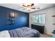 This charming bedroom features a blue accent wall and a ceiling fan at 1359 E 12Th St, Casa Grande, AZ 85122