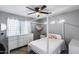 Bedroom with white four poster bed, dresser, and plenty of natural light at 1359 E 12Th St, Casa Grande, AZ 85122