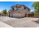 Exterior shot of the home showcasing neutral color palette, side gate and two car attached garage at 1359 E 12Th St, Casa Grande, AZ 85122