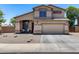 Charming two-story home showcasing a well-maintained front yard and inviting facade under a clear blue sky at 1359 E 12Th St, Casa Grande, AZ 85122