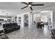 Open-concept living room featuring tile flooring, a ceiling fan, and staircase access at 1359 E 12Th St, Casa Grande, AZ 85122