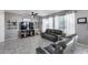 Bright living room with a ceiling fan, a TV, and views of the backyard through sheer curtains at 1359 E 12Th St, Casa Grande, AZ 85122
