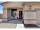 Close up of front porch featuring seating, dark wood door and manicured landscape at 1359 E 12Th St, Casa Grande, AZ 85122