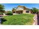 Grassy backyard with lush green lawn, landscaping, and desert rocks at 1403 W Goldfinch Way, Chandler, AZ 85286