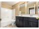 Bathroom featuring a double vanity with under-cabinet storage, shower and toilet at 1403 W Goldfinch Way, Chandler, AZ 85286