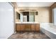 Spacious bathroom with double vanity, large mirror, soaking tub and linen closet at 1403 W Goldfinch Way, Chandler, AZ 85286