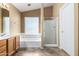 Bathroom featuring a double vanity, soaking tub under the window, and walk-in shower at 1403 W Goldfinch Way, Chandler, AZ 85286