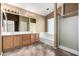 Well-lit bathroom featuring double sink vanity, soaking tub and glass-enclosed shower at 1403 W Goldfinch Way, Chandler, AZ 85286