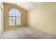 Bright and airy bedroom with arch window, neutral carpet and ceiling fan at 1403 W Goldfinch Way, Chandler, AZ 85286