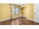 This bedroom has a window and closet, with hardwood floors and light yellow walls at 1403 W Goldfinch Way, Chandler, AZ 85286