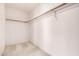 Walk-in closet with neutral carpeting and upper shelf with rail for ample storage at 1403 W Goldfinch Way, Chandler, AZ 85286