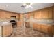 Open kitchen featuring ample wood cabinetry, stainless steel appliances, and tiled floors at 1403 W Goldfinch Way, Chandler, AZ 85286