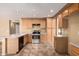 Well-equipped eat-in kitchen with stainless steel appliances and tiled floors at 1403 W Goldfinch Way, Chandler, AZ 85286