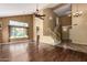 Open-concept living area with hardwood floors, high ceilings, and large windows at 1403 W Goldfinch Way, Chandler, AZ 85286