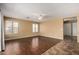Spacious living room featuring hardwood floors, ample natural light and a ceiling fan at 1403 W Goldfinch Way, Chandler, AZ 85286