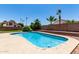 Inviting in-ground pool with tanning deck surrounded by desert landscaping and block wall for added privacy at 1403 W Goldfinch Way, Chandler, AZ 85286