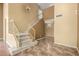 Carpeted staircase adjacent to ceramic tile flooring and neutral colored walls at 1403 W Goldfinch Way, Chandler, AZ 85286