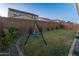 Serene backyard features a swing, privacy fence, and well-manicured landscaping creating a private oasis at 14274 W Sand Hills Rd, Surprise, AZ 85387