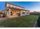 Expansive backyard with covered patio, playhouse, lush grass, and swing set for outdoor fun at 14274 W Sand Hills Rd, Surprise, AZ 85387