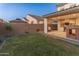 Well-maintained backyard with lush grass, covered patio, and privacy fence provides a relaxing outdoor space at 14274 W Sand Hills Rd, Surprise, AZ 85387