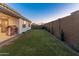 Spacious backyard features a grassy lawn, play structure, and privacy wall, perfect for outdoor activities at 14274 W Sand Hills Rd, Surprise, AZ 85387