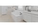 Elegant bathroom with soaking tub, dual vanities, and black fixtures at 14274 W Sand Hills Rd, Surprise, AZ 85387