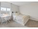 Cozy bedroom featuring carpet, white bed and desk, and natural light at 14274 W Sand Hills Rd, Surprise, AZ 85387