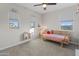Bright bedroom featuring a playful decorative style, natural light, and neutral colored walls at 14274 W Sand Hills Rd, Surprise, AZ 85387