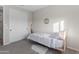 Well-lit bedroom with a single bed, plush carpet and plenty of storage with the sliding door closet at 14274 W Sand Hills Rd, Surprise, AZ 85387