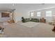 Spacious bonus room with a large sectional, play areas, and ample natural light at 14274 W Sand Hills Rd, Surprise, AZ 85387