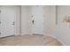 Clean entryway features wood-look tile flooring and white doors at 14274 W Sand Hills Rd, Surprise, AZ 85387