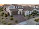 Beautiful two-story home with a well-manicured front yard, brick driveway, and two-car garage at 14274 W Sand Hills Rd, Surprise, AZ 85387
