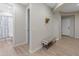 Hallway featuring a bench, tile flooring, and an arched doorway at 14274 W Sand Hills Rd, Surprise, AZ 85387