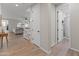 Hallway with wood floors leading to the living room, featuring white trim and doors at 14274 W Sand Hills Rd, Surprise, AZ 85387