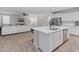 Bright open floorplan kitchen with center island, stainless appliances, and easy access to the living area at 14274 W Sand Hills Rd, Surprise, AZ 85387