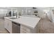Open concept kitchen with a large island and stainless steel appliances, blending into the living area at 14274 W Sand Hills Rd, Surprise, AZ 85387