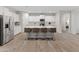 Gourmet kitchen features a large island with seating, stainless steel appliances, and ample counter space at 14274 W Sand Hills Rd, Surprise, AZ 85387