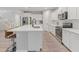 Bright kitchen with a center island, stainless steel appliances, and open access to the living area at 14274 W Sand Hills Rd, Surprise, AZ 85387