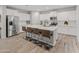 Modern kitchen with a large island, stainless steel appliances, and stylish bar stool seating at 14274 W Sand Hills Rd, Surprise, AZ 85387