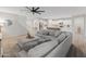 Open-concept living space boasts modern wood-look floors, a kitchen with white cabinets, and a large sectional sofa at 14274 W Sand Hills Rd, Surprise, AZ 85387