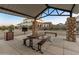 Shaded picnic area in community park features a picnic table and barbeque, perfect for outdoor gatherings at 14274 W Sand Hills Rd, Surprise, AZ 85387