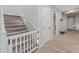 Carpeted staircase with a white banister and added safety gate at 14274 W Sand Hills Rd, Surprise, AZ 85387