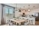 Open-concept kitchen and dining area with stylish lighting and a large window at 1482 W Ridge Rd, Apache Junction, AZ 85120