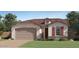 Charming single-story home with a two-car garage and well-manicured lawn at 1482 W Ridge Rd, Apache Junction, AZ 85120