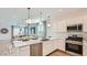 Modern kitchen with stainless steel appliances, white cabinets, and granite countertops at 1482 W Ridge Rd, Apache Junction, AZ 85120