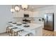 Bright kitchen featuring island with seating, modern pendant lighting, and stainless steel appliances at 1482 W Ridge Rd, Apache Junction, AZ 85120
