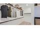 Bright walk-in closet with wood shelving, hanging clothes, and baskets for optimal organization and storage at 1482 W Ridge Rd, Apache Junction, AZ 85120