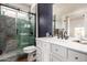 Modern bathroom with a glass shower featuring decorative tile and vanity with sink at 15034 N 30Th St, Phoenix, AZ 85032